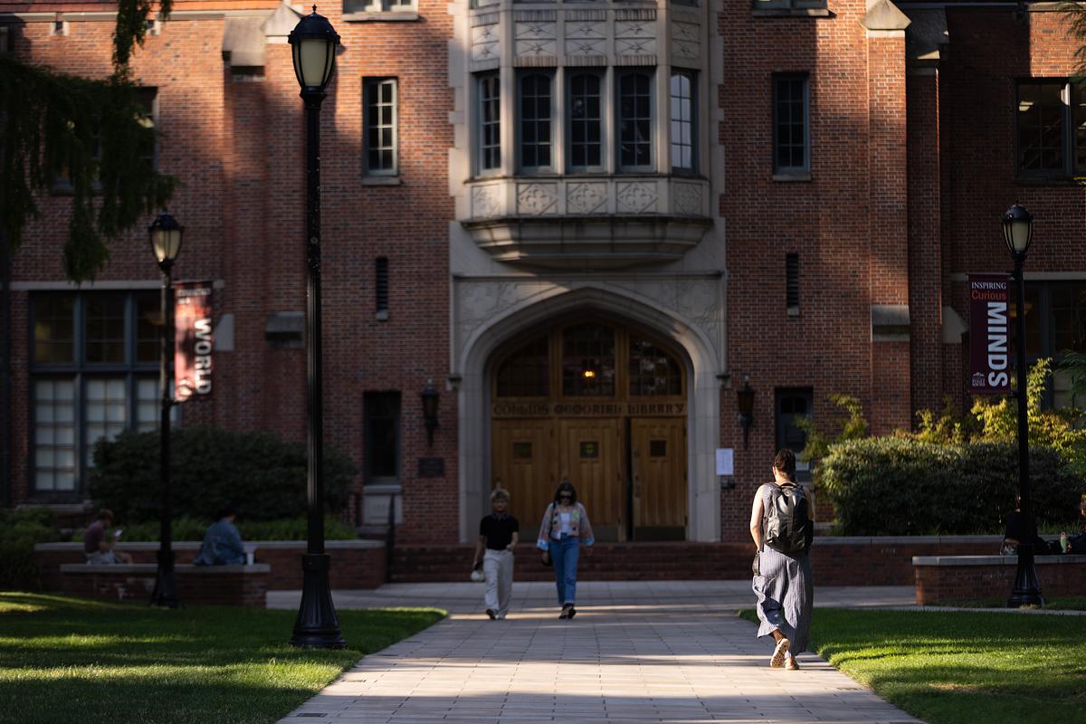 Students walk in front of Collins Library.