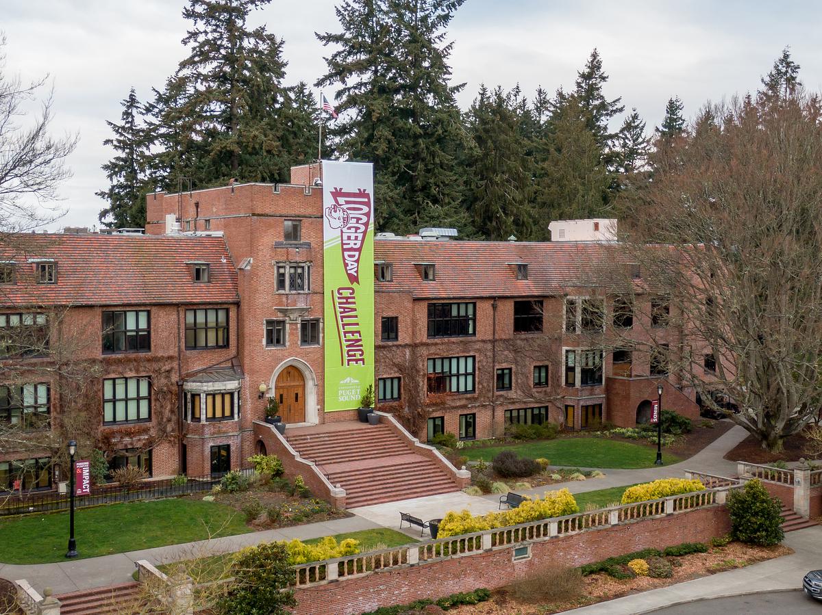 Logger Day Challenge banner hangs on the front of Jones Hall.