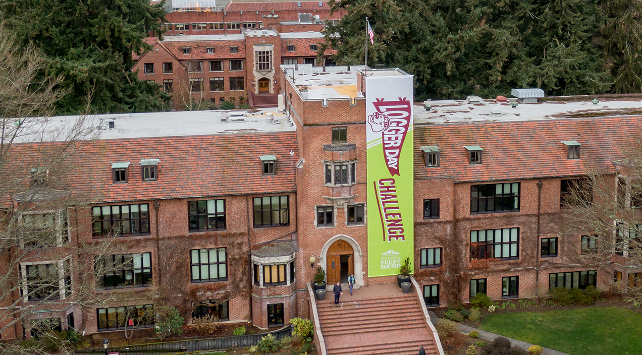 Logger Day Challenge banner hangs on the front of Jones Hall.
