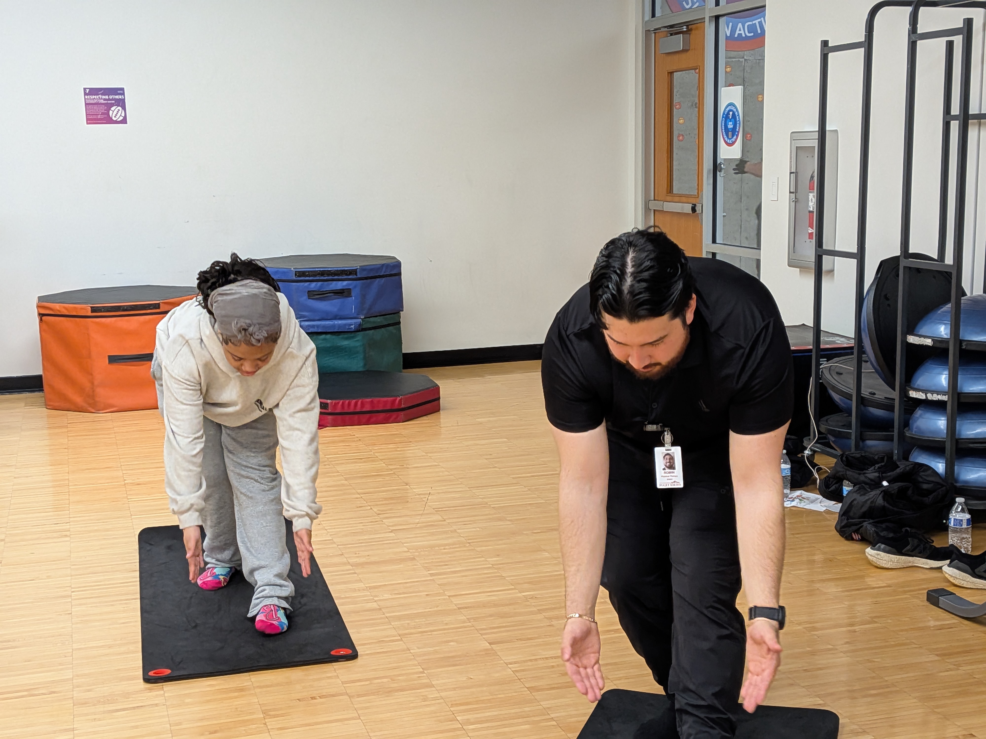 A Puget Sound student gives proper form tips while stretching. 