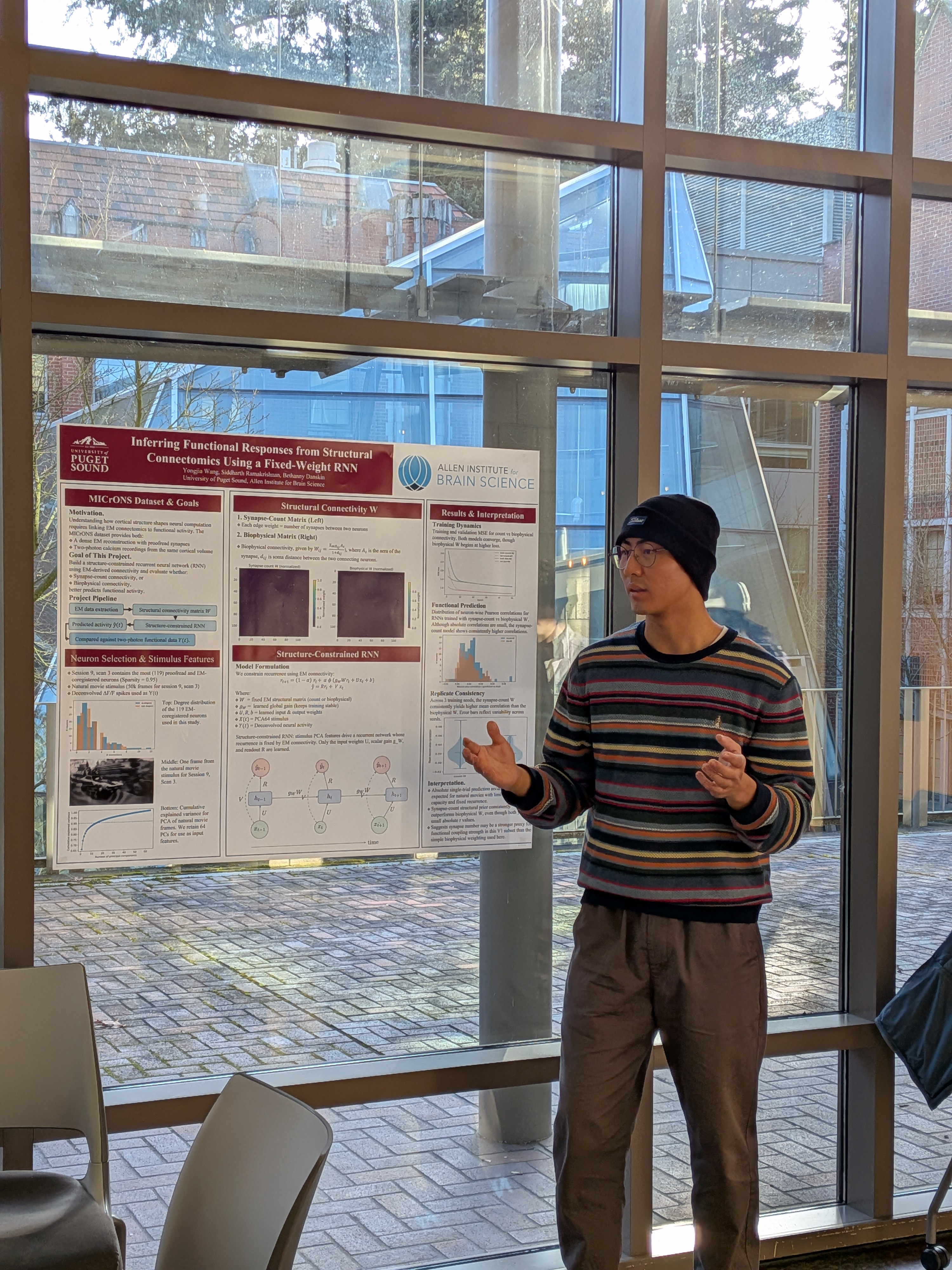 A student presents their poster. 