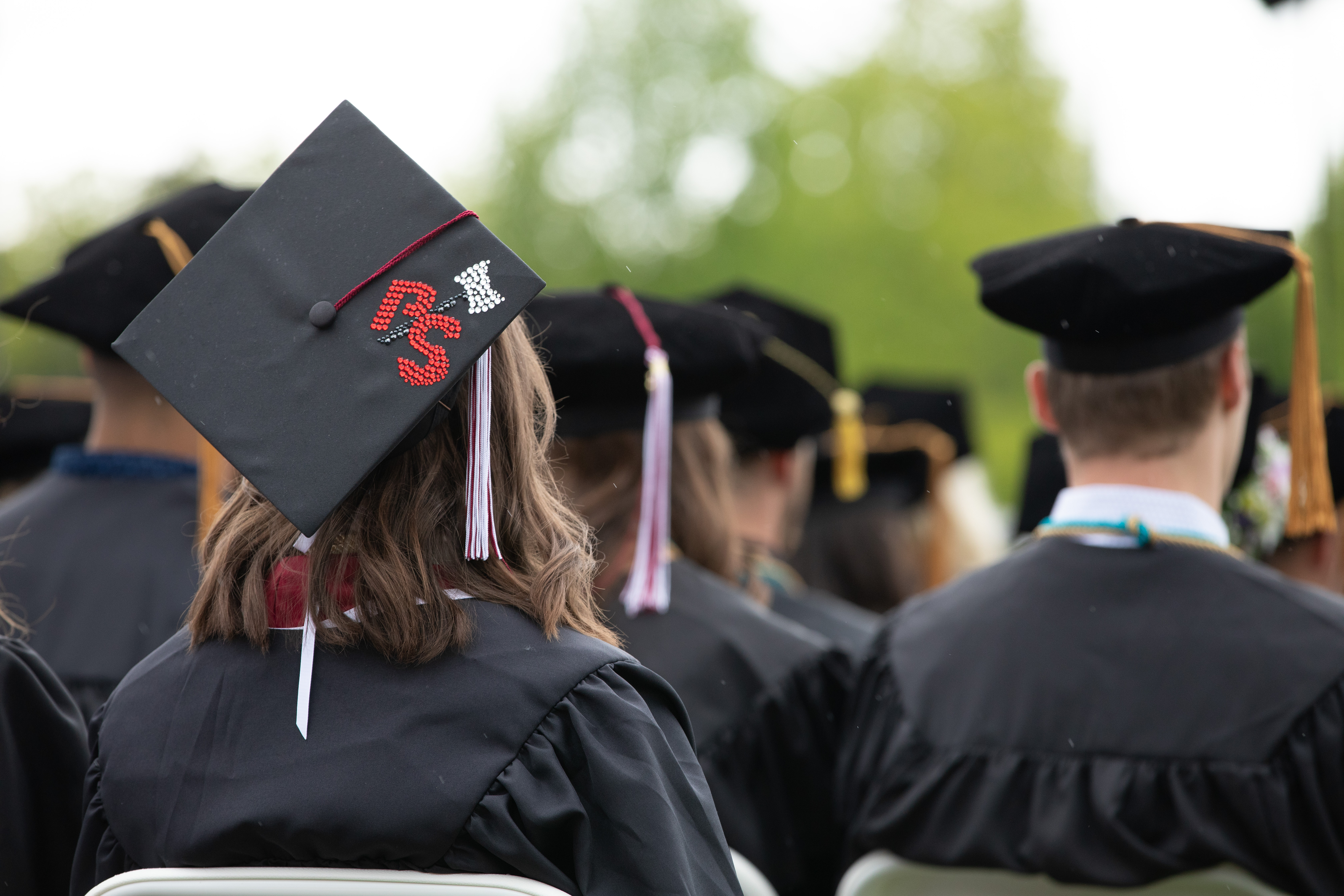 Commencement 2025 graduation cap with PS and a hatchet
