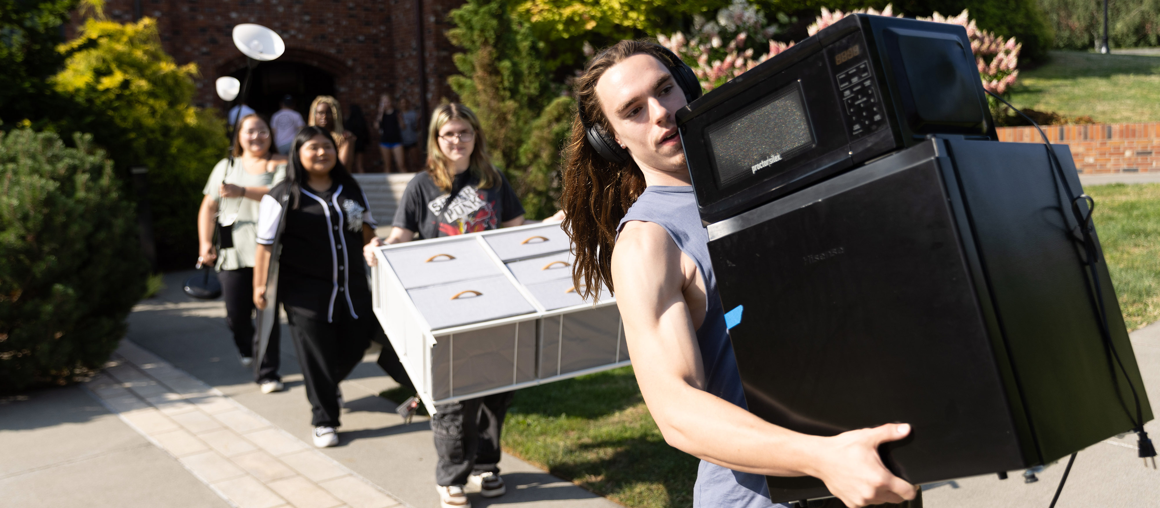 Students carry their belongings during 2026 move-in day