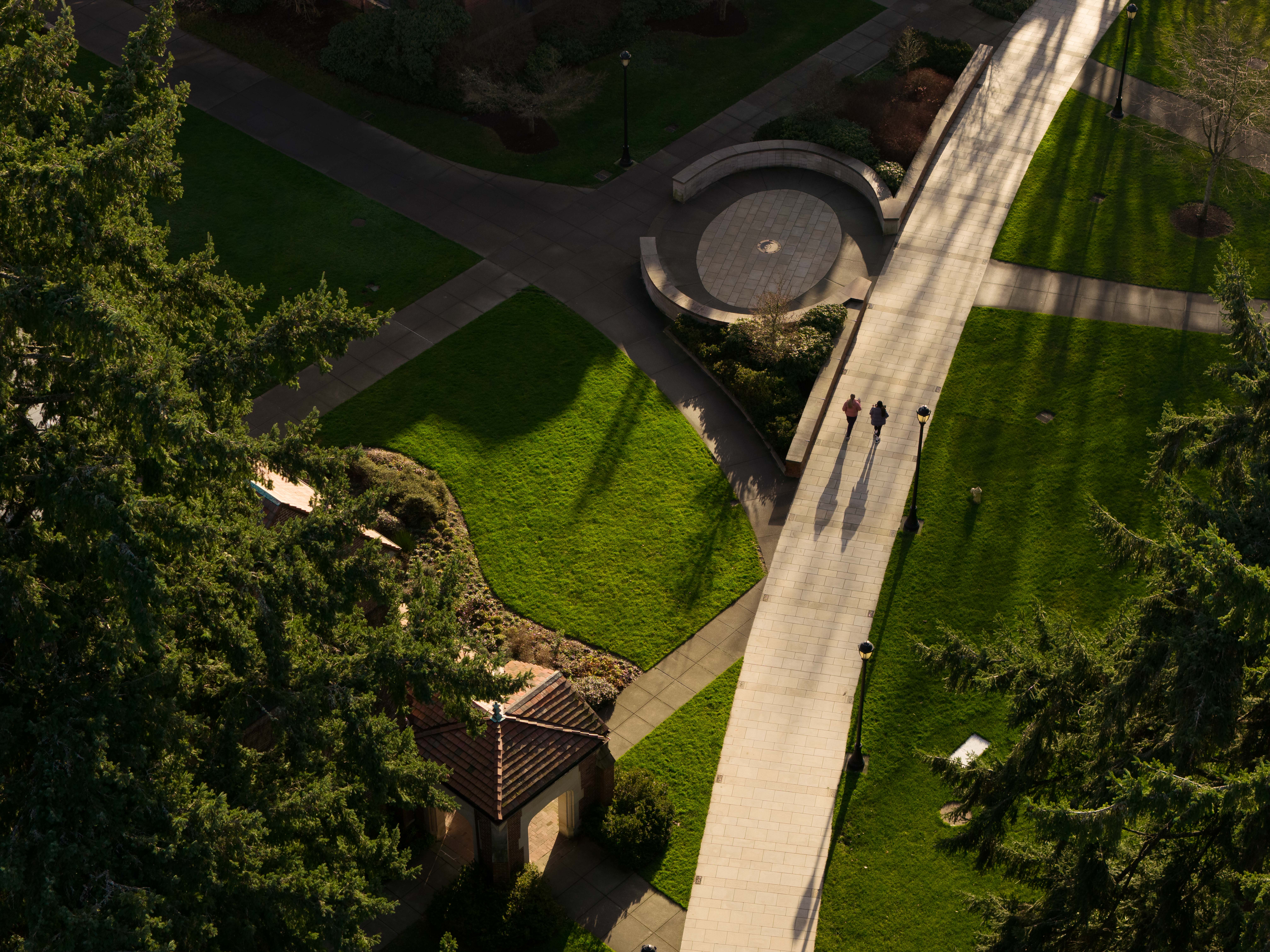 Students walk by Benefactor Plaza as seen from the air