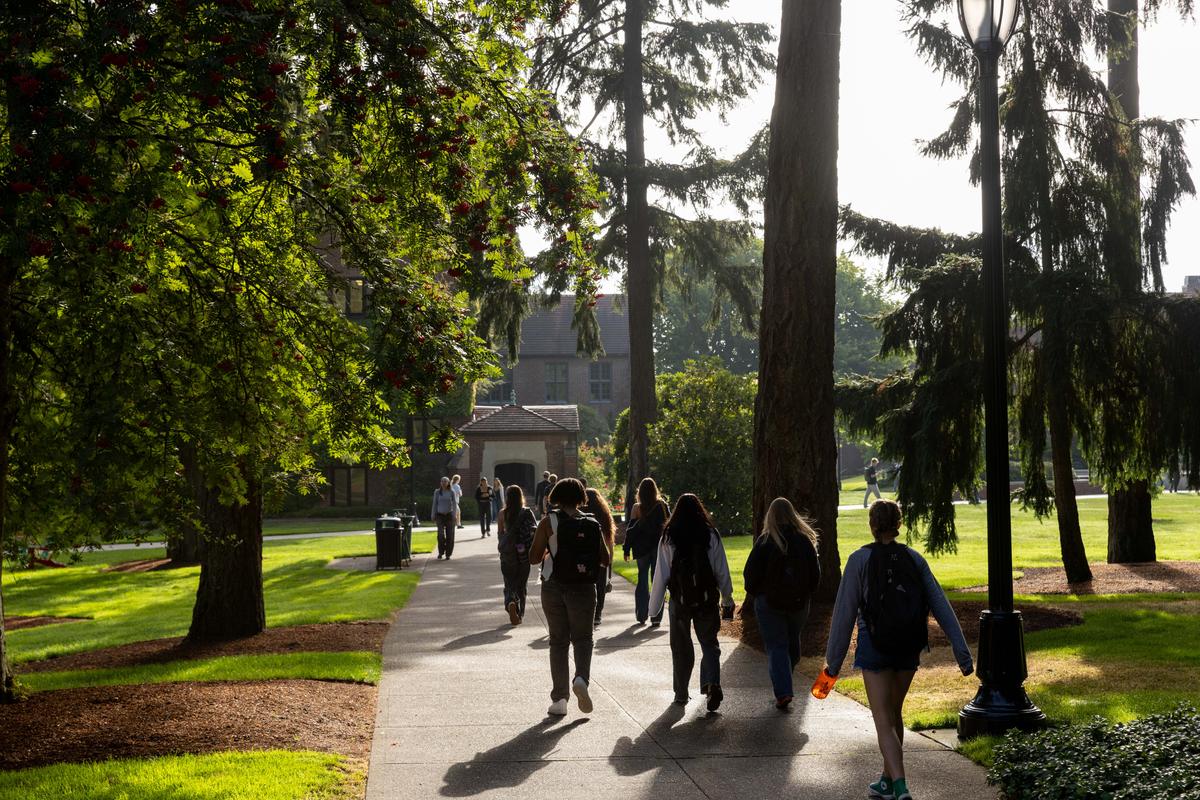 Group of students walking in the President's woods.