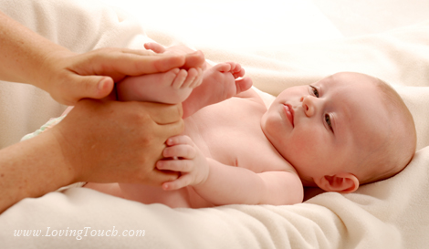 Hands caressing a baby's feet