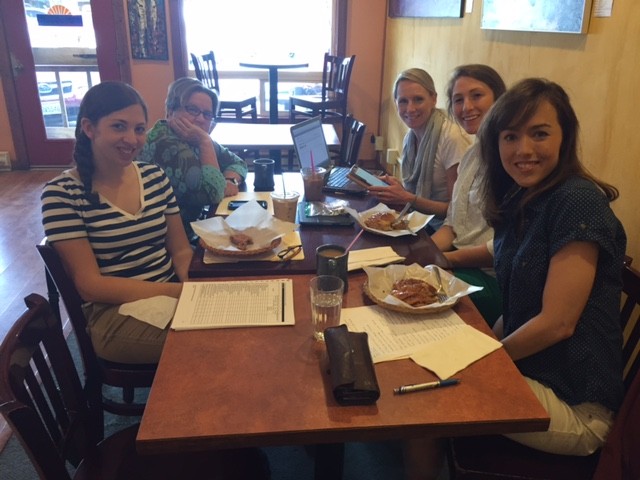 Smiling people seated at a restaurant table