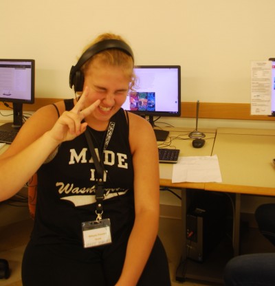 Grinning student giving the peace sign