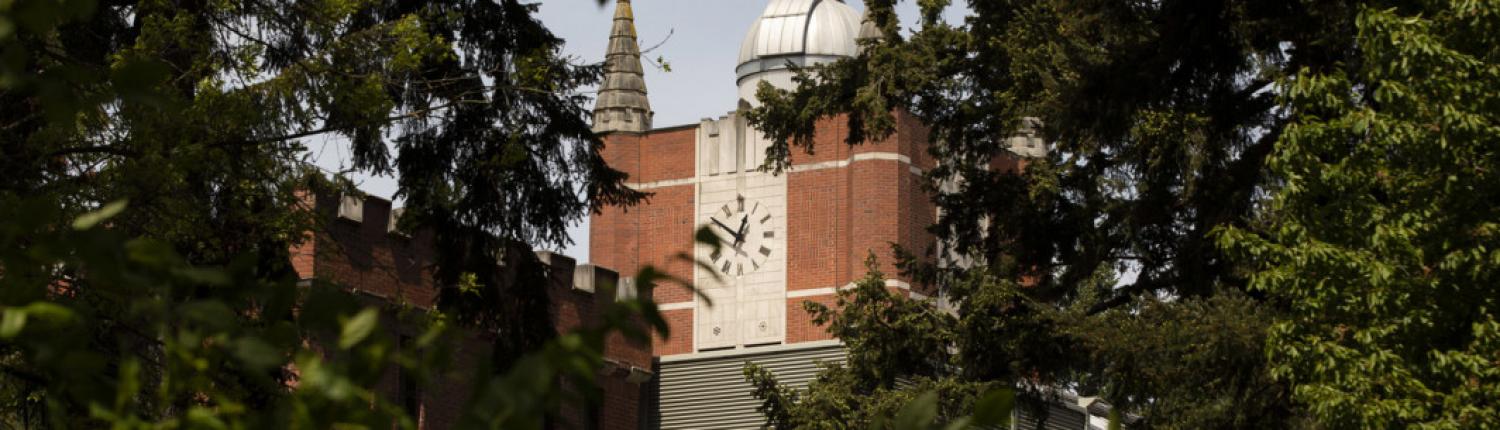 A brick building with a large clock face