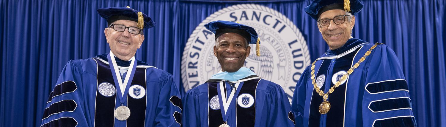 President Isiaah Crawford receives honorary degree, flanked by Joseph P. Conran (left) and Fred P. Pestello (right)