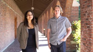 Oliver Wright of Granada Hills, California, and Maya Gomez of Rocklin, California face the camera while standing under red brick arches. 