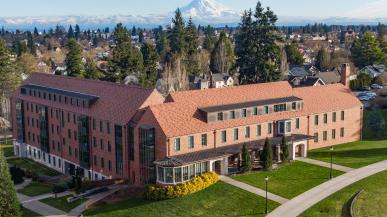 University campus is seen from above with Mount Rainier behind it. 
