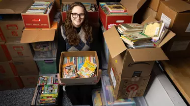 Hurley Scholar Abi Longbottom ’26 with some of the books she's collected for students in Kenya.