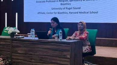 Prof. Hajung Lee speaks into a microphone