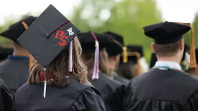 Commencement 2025 graduation cap with PS and a hatchet