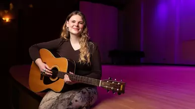 Madison Hening ’26 with her guitar