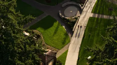 Students walk by Benefactor Plaza as seen from the air