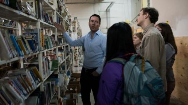 People looking at a shelf of books