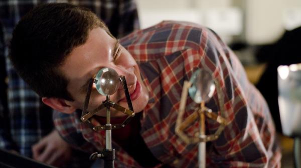 Student looks through a magnifying glass