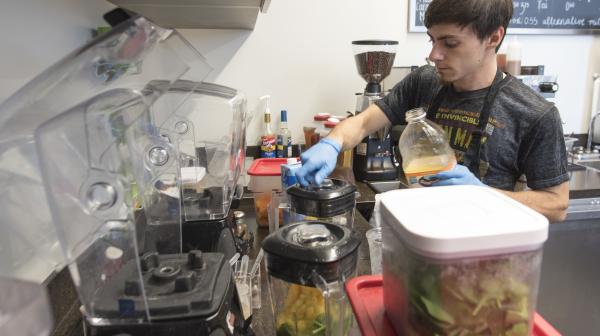 A student works on campus in one of the dining facilities