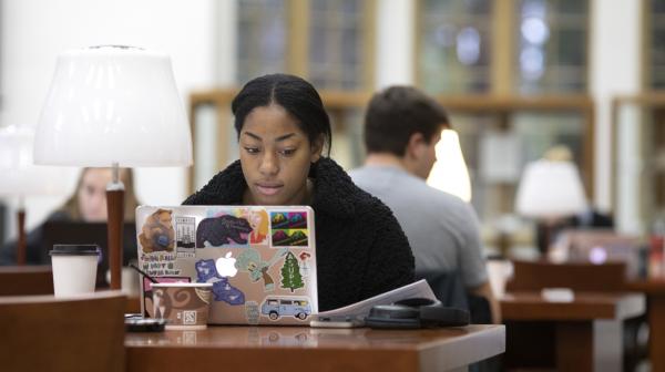 Student studies in the Reading Room of Collins Memorial Library