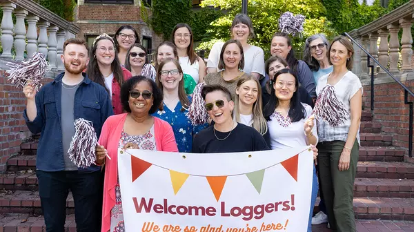 Members of CHWS welcome Loggers to campus with a banner.