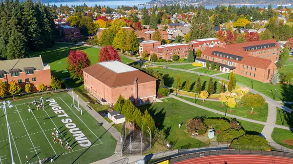 Aerial view of campus with Tacoma's North End neighborhood and Commencement Bay in the background