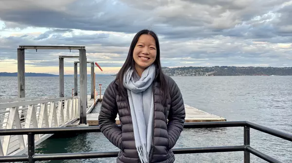 picture of a person with a dock and water in the background