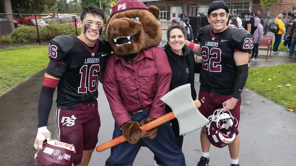 Grizz with football players and Athletic Director Chelsea Herman