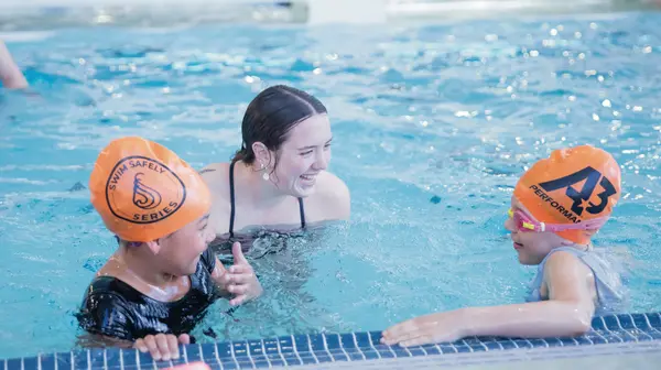 Group of swimmers chatting in the pool