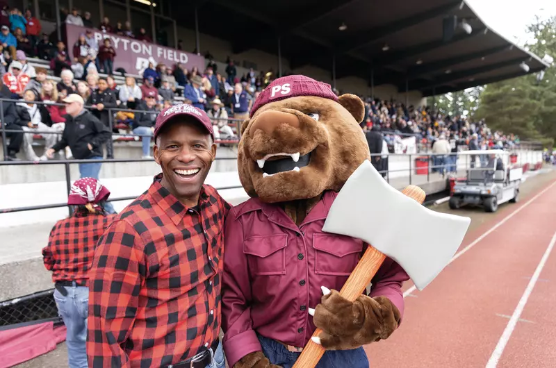 President Crawford at the Homecoming & Family Weekend football game with Grizz