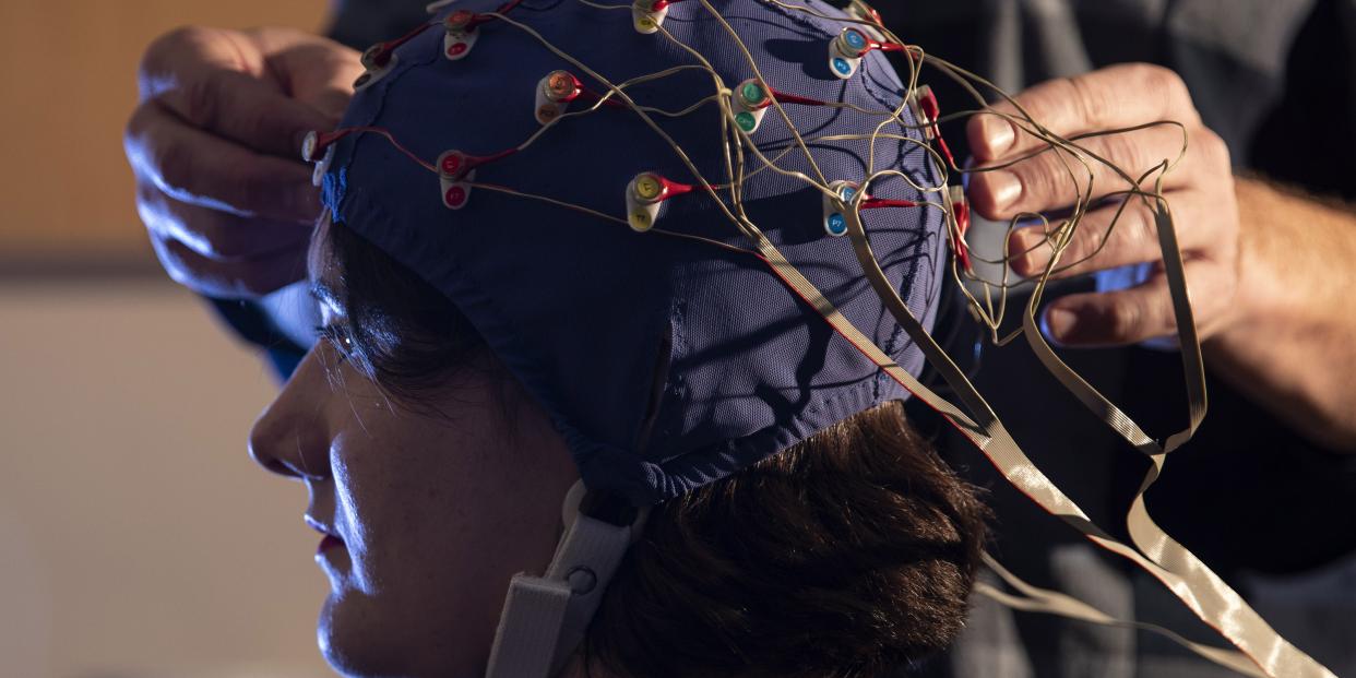 Student taking part in a study with an electrode cap on their head