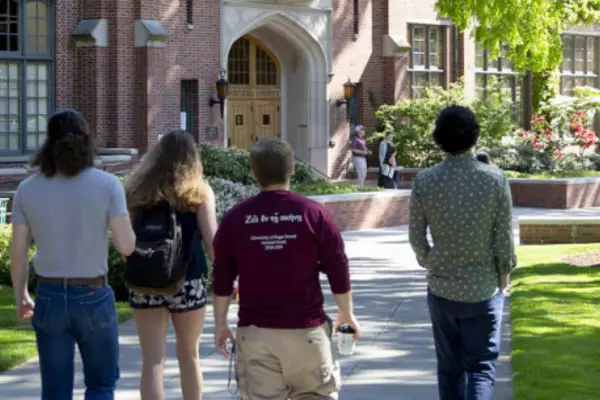 A group of people walking towards a building