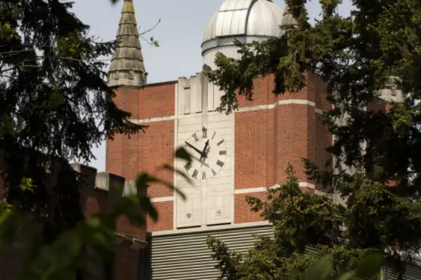 A brick building with a large clock face