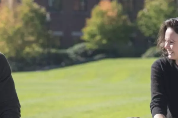 Two people sitting outside