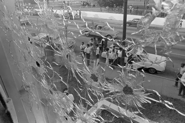 bullet holes on glass shield