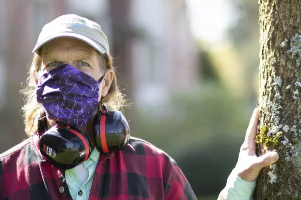 Andy Lambert standing by a tree