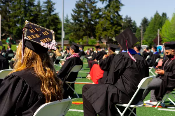 Graduates sit on Peyton Field for Commencement 2021