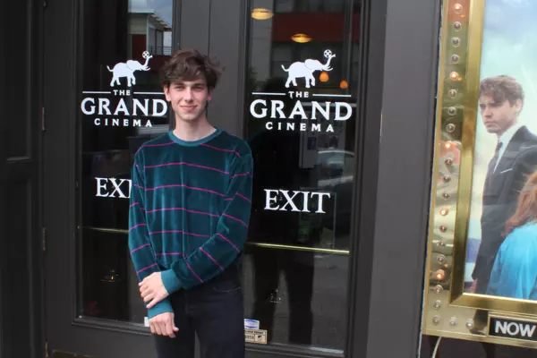 Student standing in front of a building