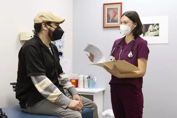 Capriana Jiang ’22 (right) with a visitor of Tacoma's Neighborhood Clinic