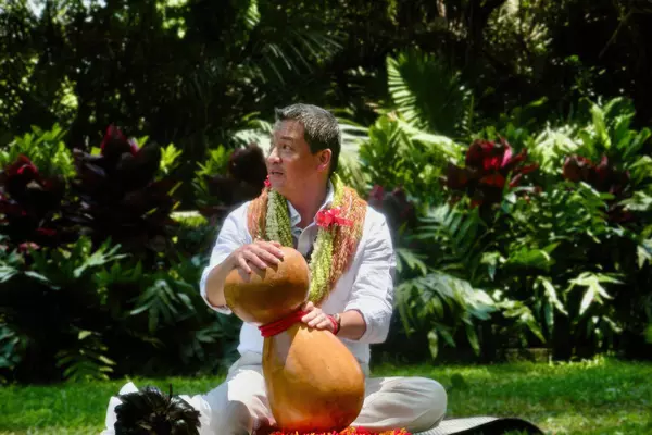 Michael Pili Pang ’84 performing hula outdoors.