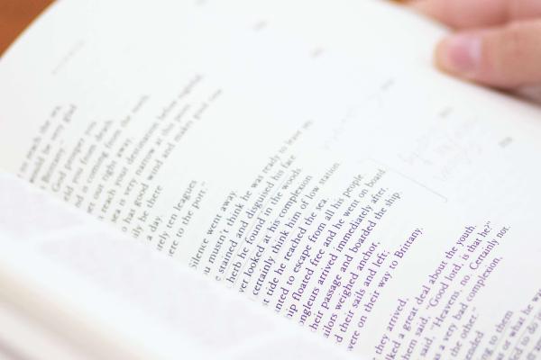 Hands holding an annotated text