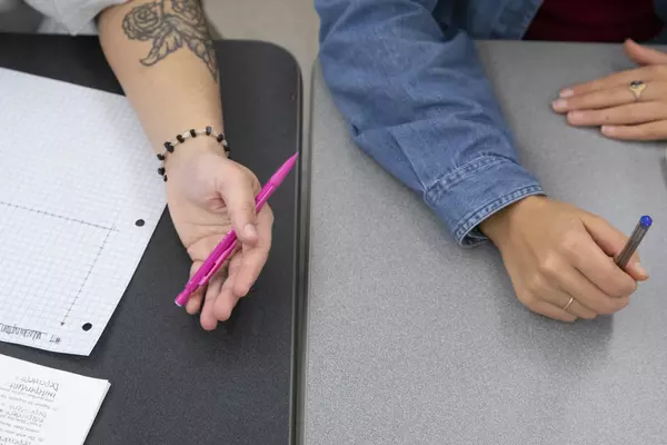 Hands of two students participating with the FEPPS program.