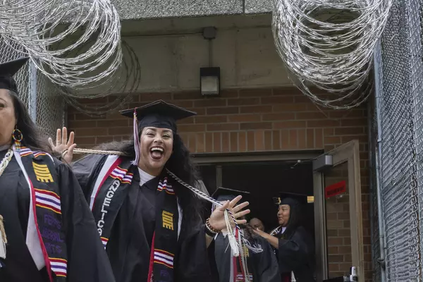 A smiling grad at the FEPPS Commencement ceremony in June 2024.