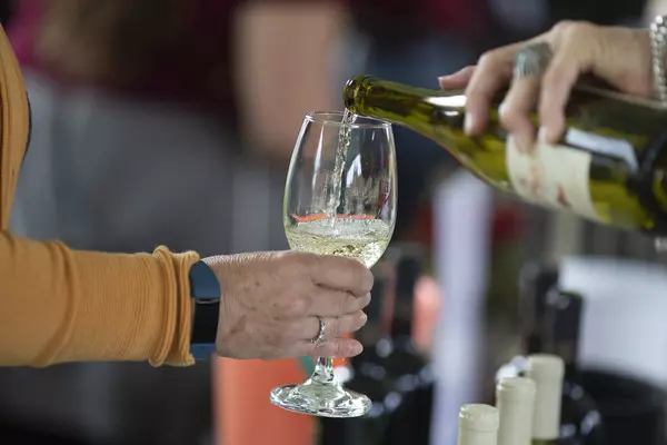 White wine pouring into a wine glass.