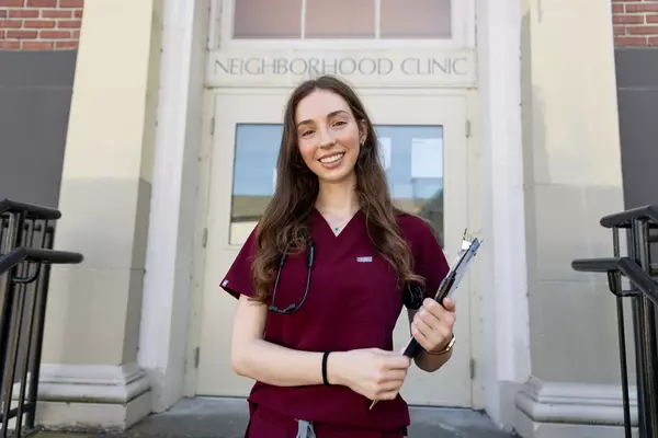 Cecilia Turetzky in front of the Neighborhood Clinic.
