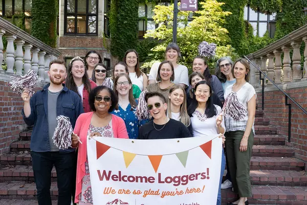 CHWS team with a Welcome Loggers banner