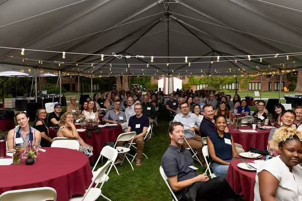 faculty sit at tables 