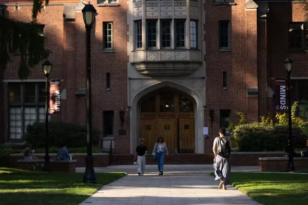 Students walk in front of Collins Library.