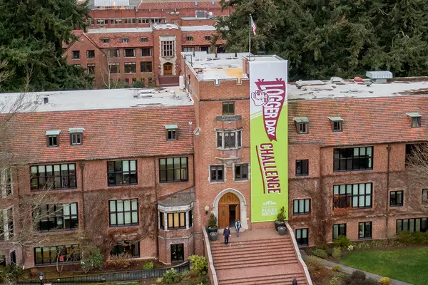 Logger Day Challenge banner hangs on the front of Jones Hall.